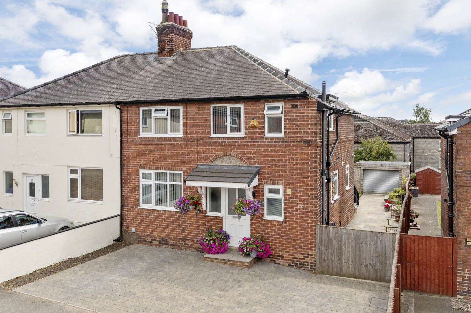 Exterior property photography of a red-brick semi-detached house in Leeds with block-paved driveway